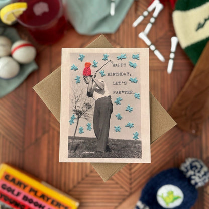 Greeting card with vintage-style photo of a golfer on a wooden surface with various items.