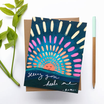 Greeting card with colorful sun design and text on a white background