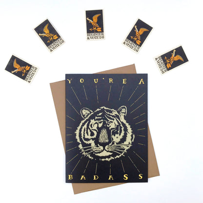 Greeting card with tiger design and text, surrounded by stamps.