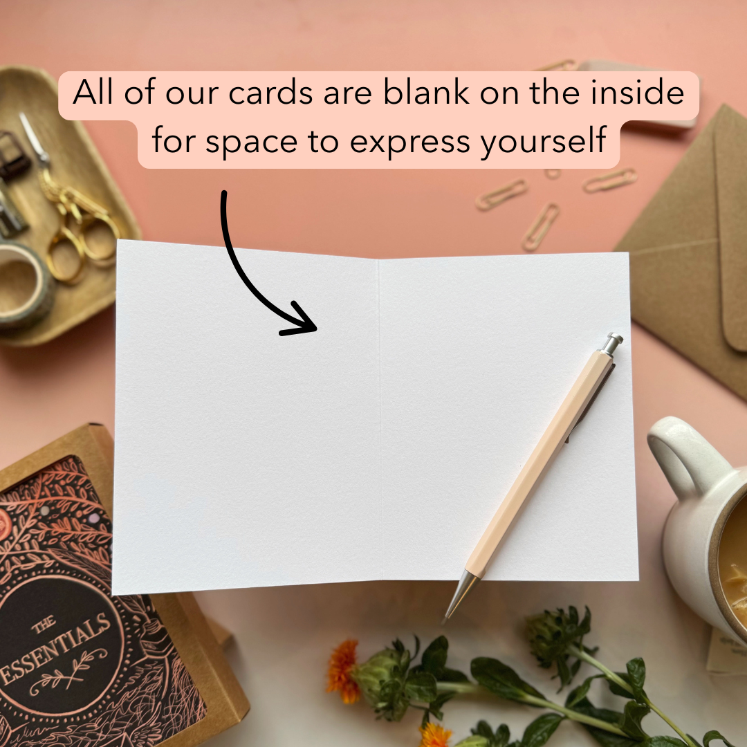 Blank card with pen and stationery items on a pink background